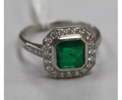 An Art Deco style platinum, emerald and diamond cluster ring, size P.