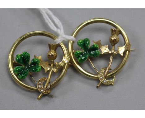 A pair of yellow metal, enamel and seed pear set shamrock and thistle openwork circular brooches, 21mm.