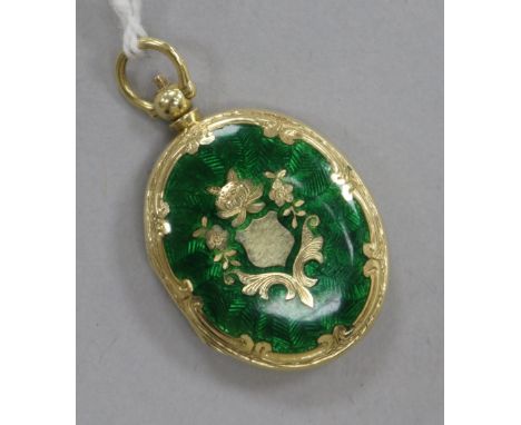 A 15ct gold and green enamel oval locket pendant, 30mm.