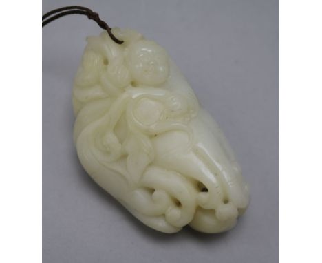 A Chinese white jade carving of a boy clambering on a finger citron, carved in relief with leaves, a bat and lingzhi fungus, 