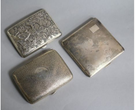 Two silver cigarette cases and a Chinese white metal cigarette case decorated with dragons and prunus, gross weight 8.8 oz.