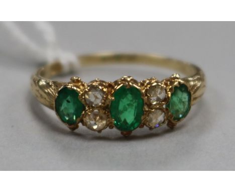 A 15ct gold, emerald and diamond seven stone ring, size O.