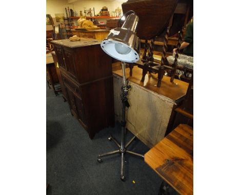 A RETRO CHROME EFFECT ANGLE-POISE LAMP ON CASTORS