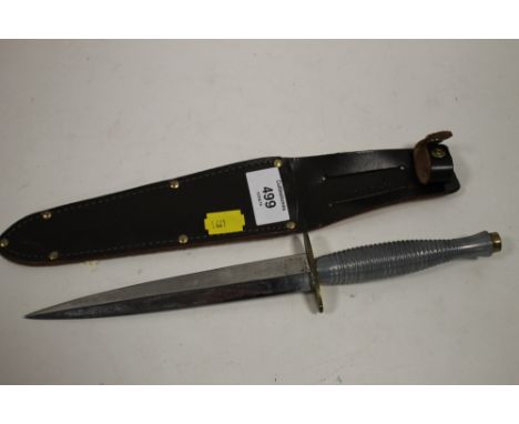 A COMMANDO KNIFE IN SHEATH 