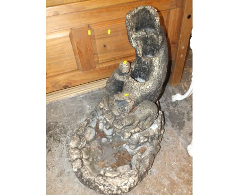 A STONEWARE GARDEN WATER FEATURE OF OTTERS ON A TREE TRUNK H 74 CM