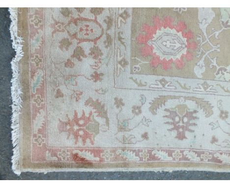 AN EASTERN WOOLLEN 20TH CENTURY RUG / CARPET, the all over floral pattern on a mainly beige / cream ground, 288 x 214 cm