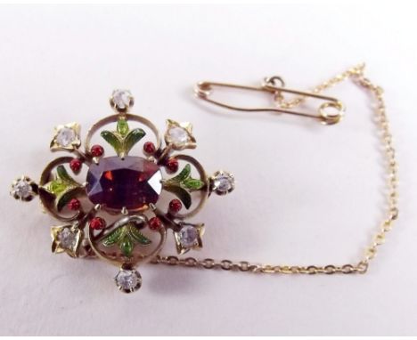 A small Victorian gold brooch set semi-precious stones and enamel in suffragette colours