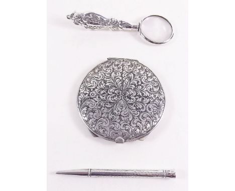 A silver magnifier, silver pencil and white metal compact 