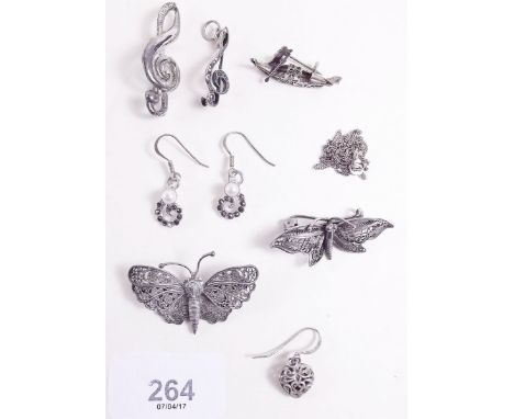 Two white metal filigree butterfly brooches, a marcasite and silver treble clef pendant (converted from a brooch), a filigree