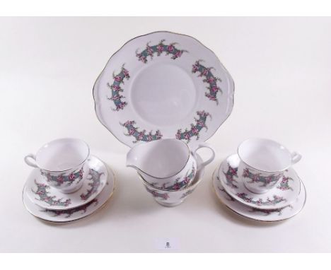 A Royal Kent floral tea service comprising six cups and saucers, milk and sugar