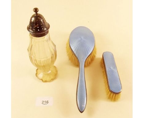 Two silver and enamel brushes and a silver topped cut glass caster 