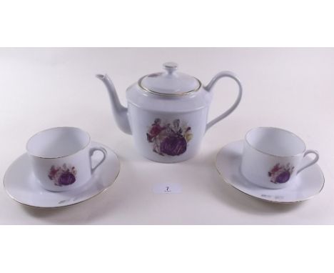 A Limoges tea service printed courting couple comprising: teapot, twelve cups and saucers and twelve tea plates 