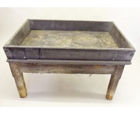 A large slate farm trough or sink with drainage hole to base, raised on a  wooden stand 3ft 5" x 2ft 3" - possibly used for s