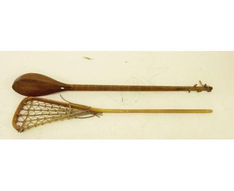 A Middle Eastern stringed instrument and old lacrosse stick 