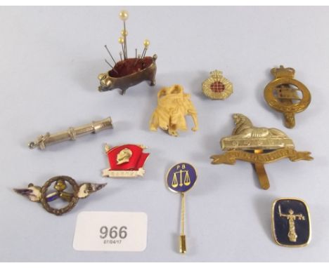 A box of badges and pig pin cushion 