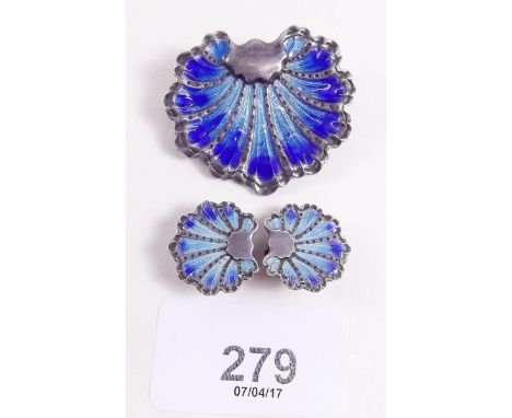 A sterling silver and blue enamel shell form brooch and pair of earrings