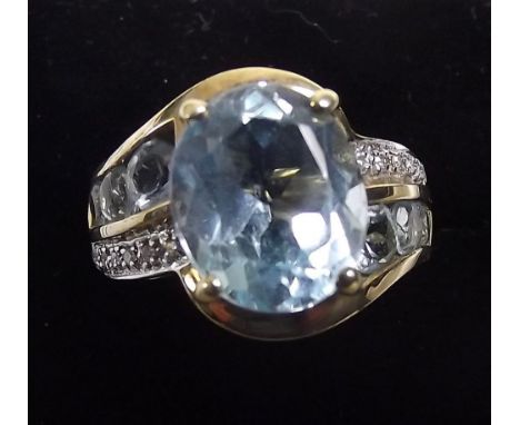 A 9ct gold aquamarine and diamond ring on aquamarine and diamond set shoulders size M.5