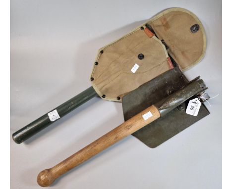 Two entrenching tools, one dated 1965, both with wooden handles, one with canvas cover. (B.P. 21% + VAT)