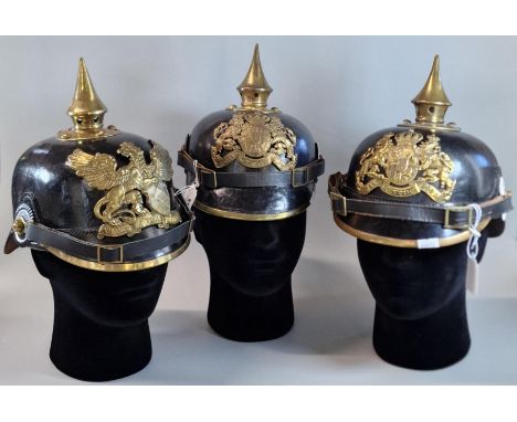 Group of three reproduction Imperial German Pickelhaulb leather and brass mounted Officer's dress helmets. (3) (Mannequin hea
