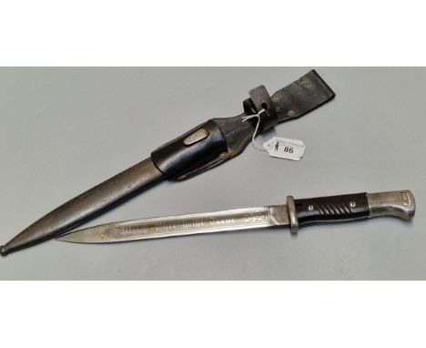 German WWII period K98 bayonet, blade marked WKC and having eagles head pommel with black wooden grip and leather frog, steel