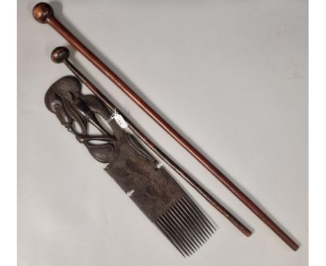 Two hardwood Knobkerries, 70cm and 92cm approx. together with a large African hardwood figure decorated comb with foliate pok