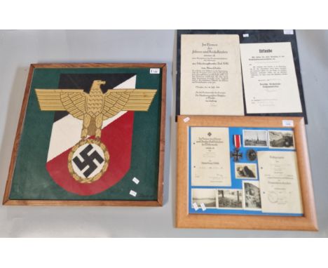 Framed tapestry of a Third Reich Eagle insignia. 48x52cm approx. Together with framed montage of WWI photographs, documents a