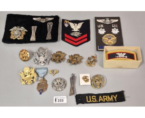 Collection of American Military fabric and metal badges to include: Missile Battery badges, US Navy anchor, cap badges, shoul