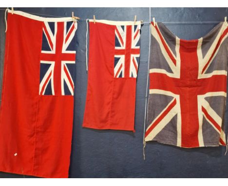 Three British flags to include two Merchant Navy Red Ensign flags (145x68cm and 98x48cm approx.) and a vintage Union flag (11