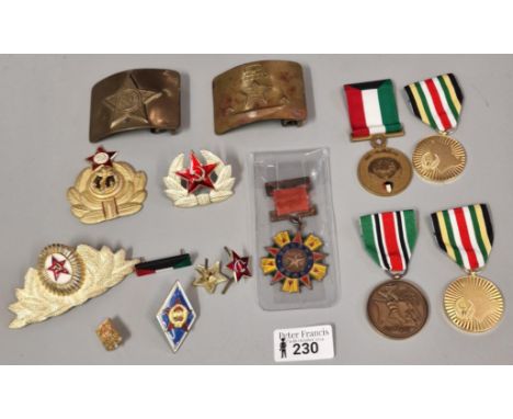Collection of Soviet Russian belt buckles and cap badges, various together with a Kuwaiti Liberation Medal, a Bahrain Liberat