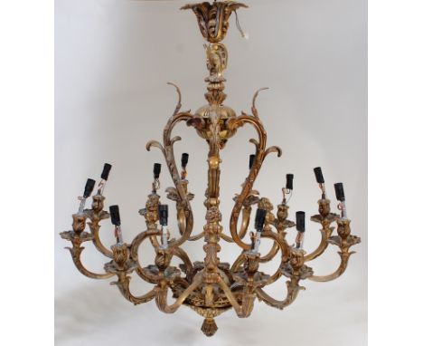 A Rococo Revival gilt metal twelve light electrolier, of good size, fully converted for electricity, each candle arm with app