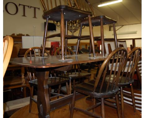 An Ercol dark elm dining table, length 150cm, together with a set of six Ercol dark elm stickback dining chairs (7)