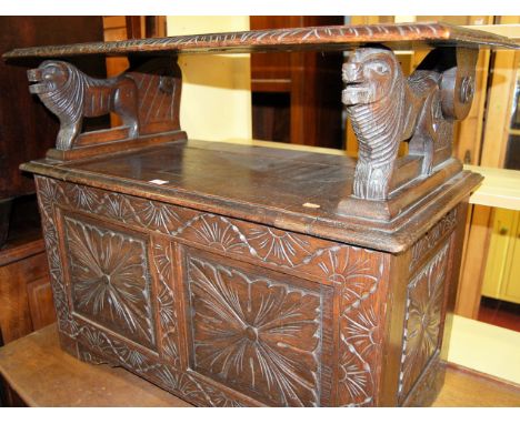 A circa 1900 low relief carved oak fold-lover monks bench having typical hinge two panelled box seat base, width 92cm