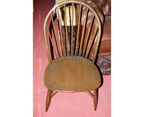 A set of four Ercol dark elm stickback dining chairs