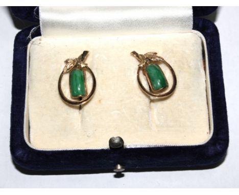 A boxed pair of jade earrings set in 14 carat gold