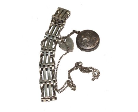 A silver gate bracelet and a silver locket on neck chain