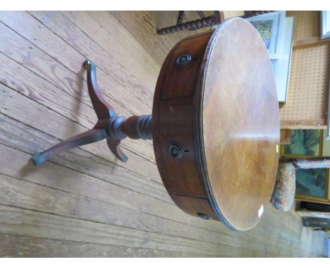 A small 19th century mahogany drum table, the circular top with four drawers and dummy drawers on a turned support and tripod