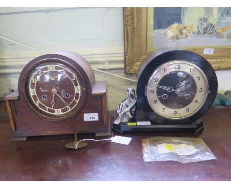 An Art Deco ebonised mantel clock, with a figure of a seated girl and a silvered chapter ring, striking on a gong, 22cm high 