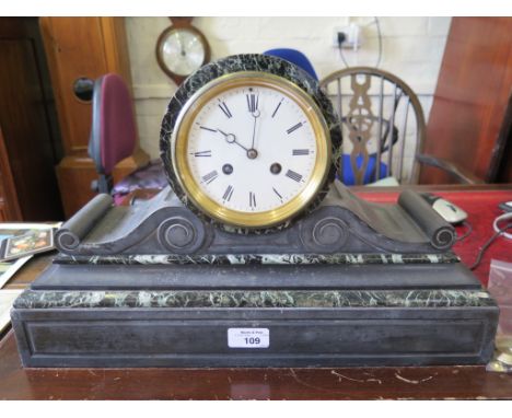 A Victorian slate and green marble mantel clock, with enamel dial, scroll supports and twin train movement striking on a bell