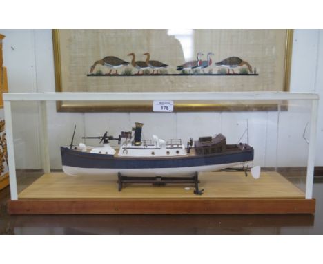 A scale model of a Naval patrol vessel, in a perspex case, 45cm long