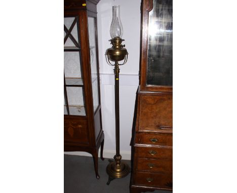 A brass standard oil lamp, on circular stepped base