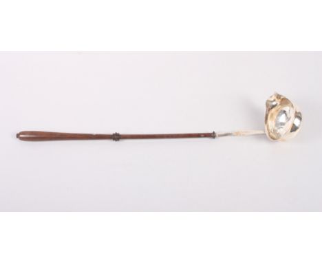 A Georgian bright cut white metal punch ladle with turned mahogany handle, 15 1/2" long