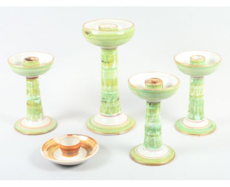 An Aldermaston pottery green glazed candlestick, by Alan Caiger Smith, 10 3/4" high, three similar smaller, 7 3/4" high, and 