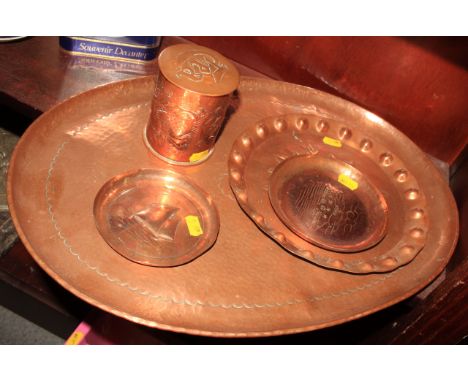 A Newlyn copper tea caddy, decorated fish, a large Newlyn tray with hammered decoration, a Newlyn copper pin dish, decorated 