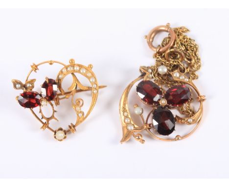 A yellow metal gem set, Art Nouveau style pendant, stamped 9ct, on gilt chain, and a similar heart-shaped brooch