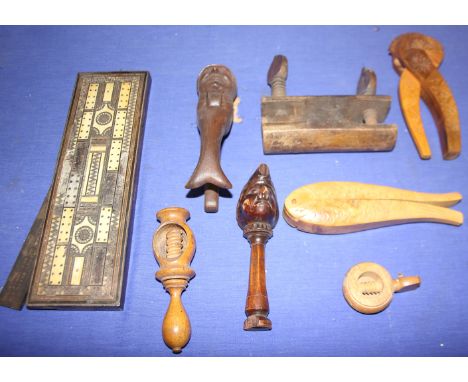 A carved wood "Scrooge" nutcracker, a carved wood "Mr Punch" nutcracker (damages) other carved wood nutcrackers, a cribbage b