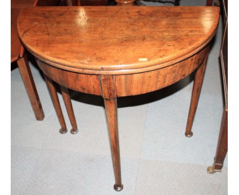 A Georgian mahogany circular fold-over top card table, on turned supports with pad feet, 30" dia