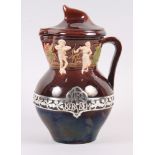 A Portuguese jug and cover, decorated with figures and pierced silver band and inscription "turn