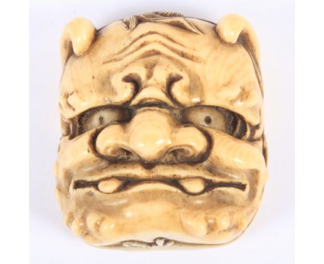 A Japanese Meiji period carved ivory mask Netsuke, Oni to the front, Okame to the back, 2" high