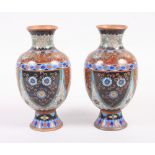 A pair of cloisonne oviform vases with chrysanthemum panels, on circular feet, 7" high (one slight