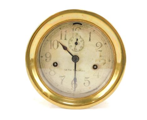 A brass cased ship's clock, the circular silvered dial bearing Arabic numerals, bearing name Seth Thomas, subsidiary seconds 